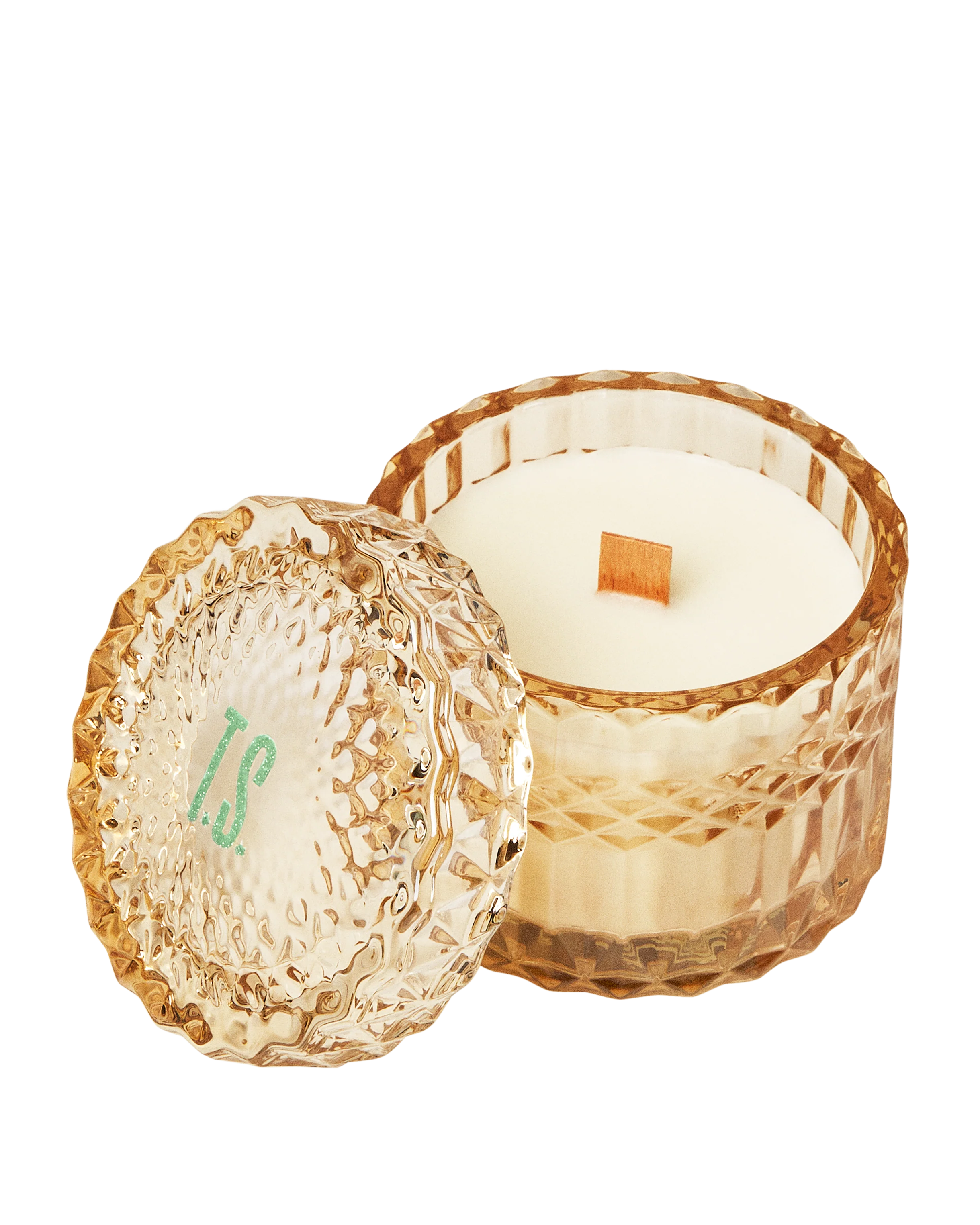 Decorative candle in a textured gold holder on a white background