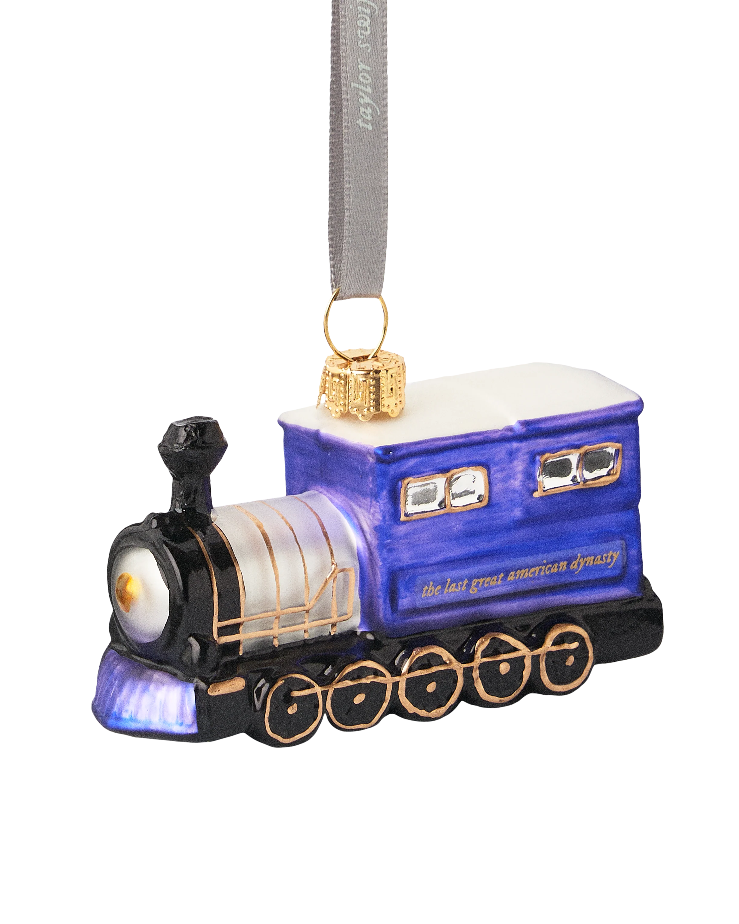 Decorative train ornament with blue engine and gold accents on a white background